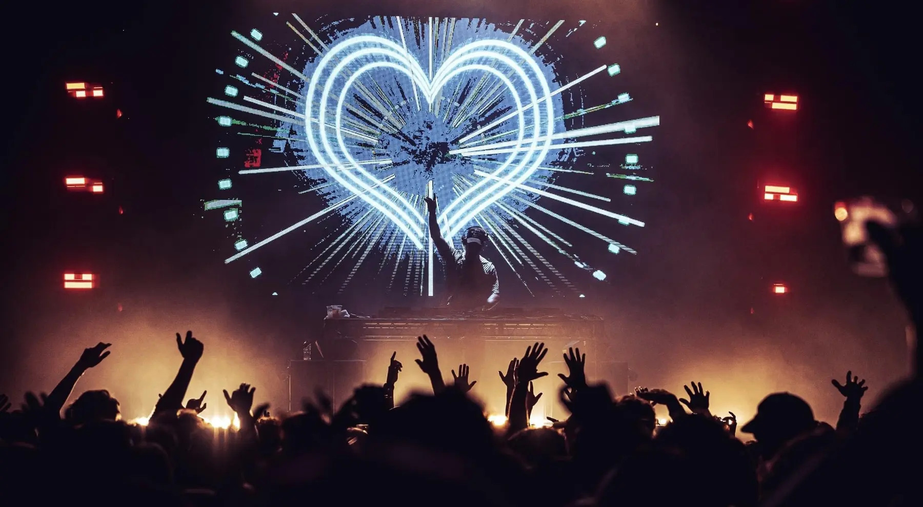 Electric Avenue crowd beneath a large heart-shaped festival visual